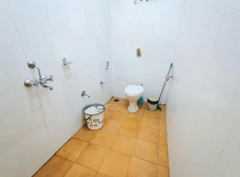 Attached tiled bathroom with shower and toilet