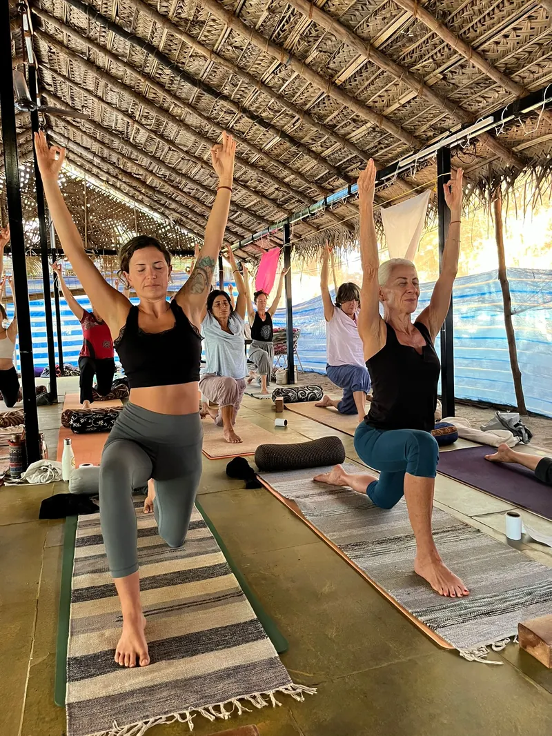 Guided yoga practice in the thatched shala