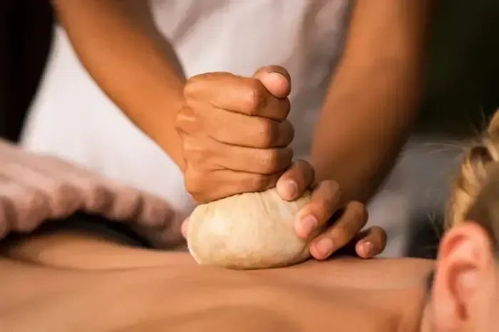 An Ayurvedic therapy treatment using a herbal compress