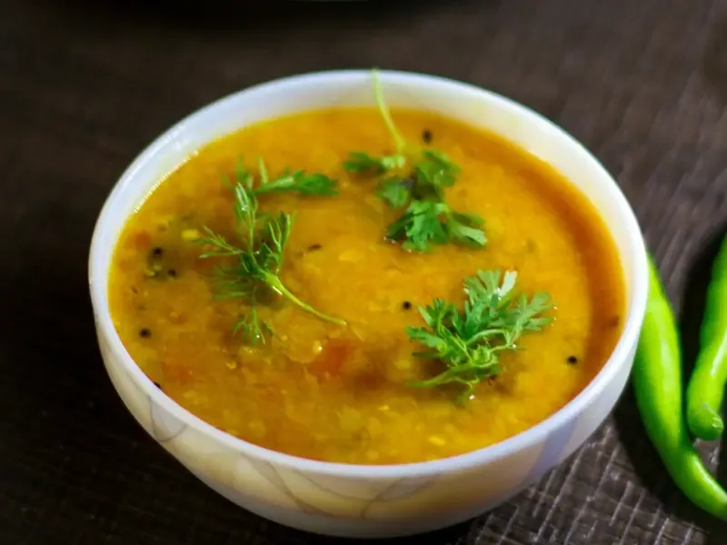 A bowl of dal served with herbs