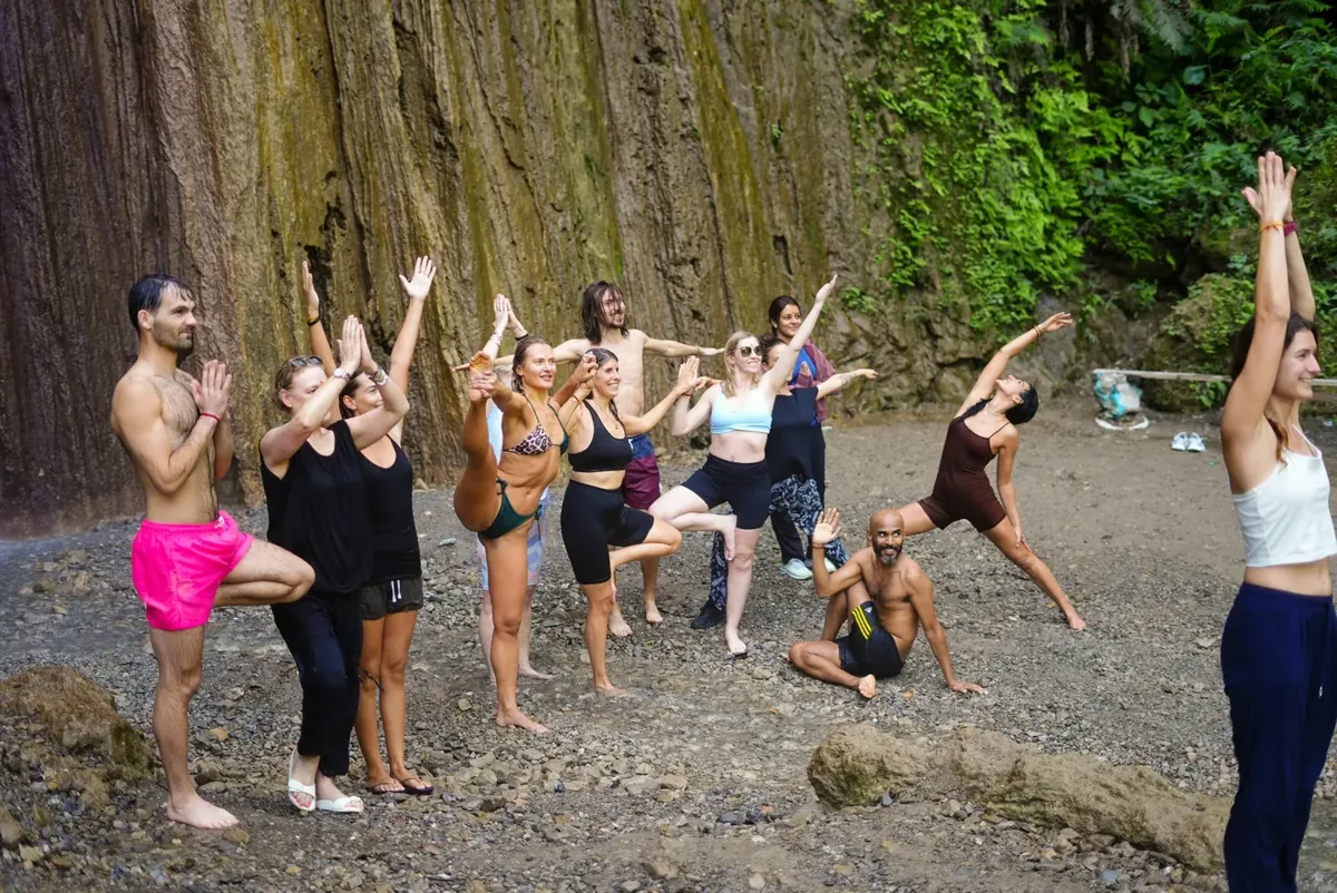 A group enjoying an outing beside a waterfall